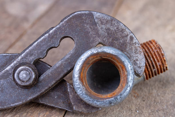 istock Hydraulic wrench and steel pipes on a workshop table. Minor mechanical work. Light background. 1135830903