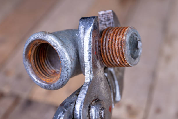 istock Hydraulic wrench and steel pipes on a workshop table. Minor mechanical work. Light background. 1135831185
