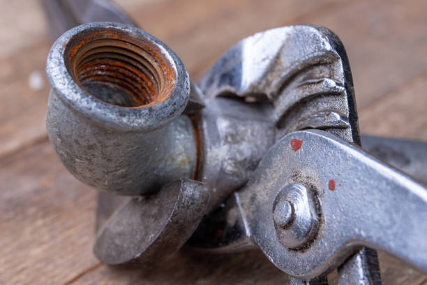 istock Hydraulic wrench and steel pipes on a workshop table. Minor mechanical work. Light background. 1135831965