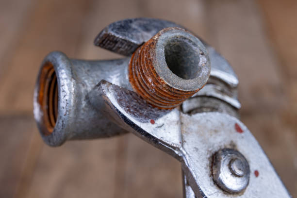 istock Hydraulic wrench and steel pipes on a workshop table. Minor mechanical work. Light background. 1135831990