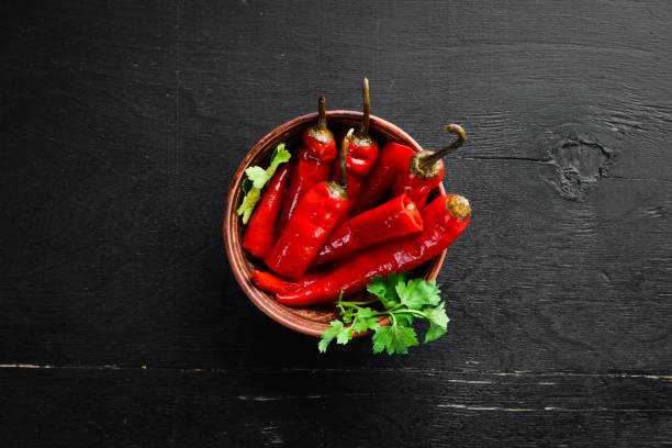 istock Marinated chili pepper in a bowl. Top view. Free space for your text. 1135832450