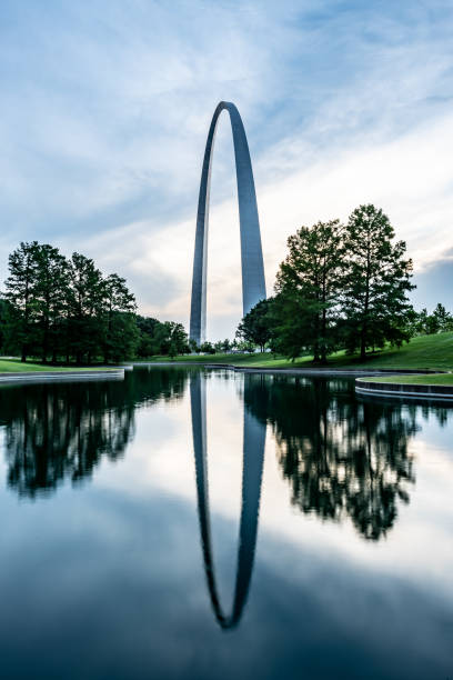 Gateway Arch Reflects in Pond Saint Louis, United States: June 12, 2018: Gateway Arch Reflects in Pond in morning light jefferson national expansion memorial park stock pictures, royalty-free photos & images