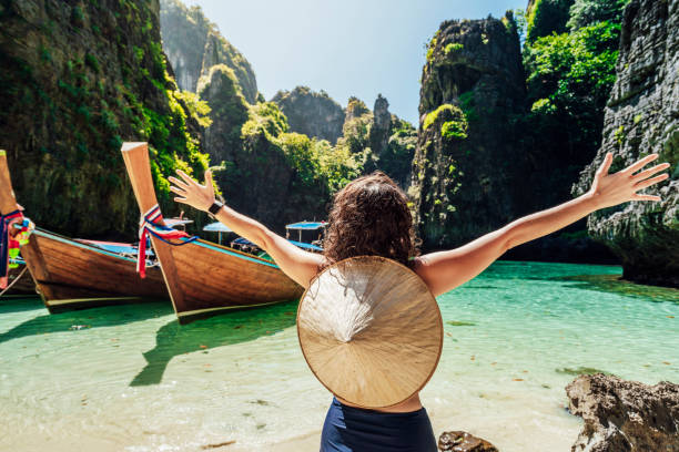 istock Young woman on a beautiful beach in Thailand with longtail boats, Phi Phi Island 1135834028