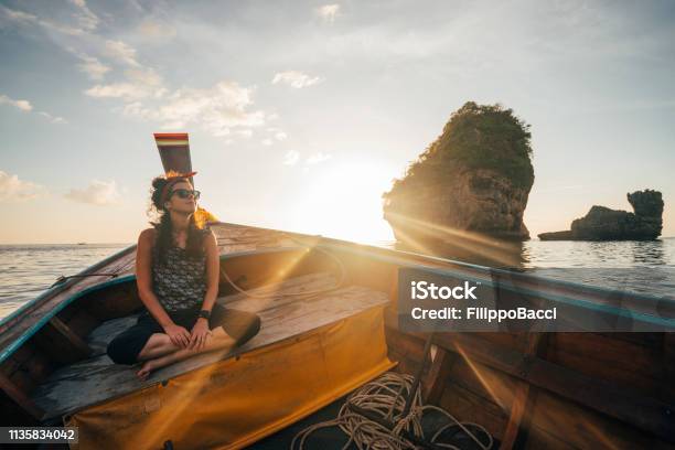 Young Woman On A Longtail Boat In Thailand During Sunset Phi Phi Island Stock Photo - Download Image Now