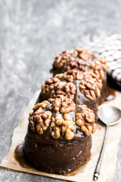 istock Sticky chocolate and walnut puddings on wooden table 1135836917
