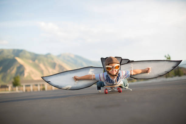 istock Young Boy Flying on Skateboard with Wings 1135838022