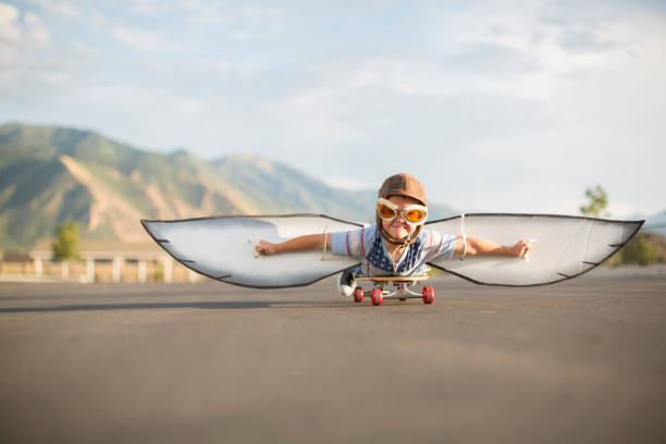 istock Young Boy Flying on Skateboard with Wings 1135838024