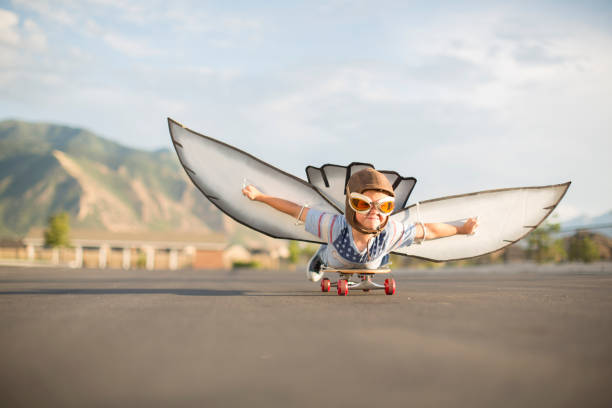 istock Young Boy Flying on Skateboard with Wings 1135838028