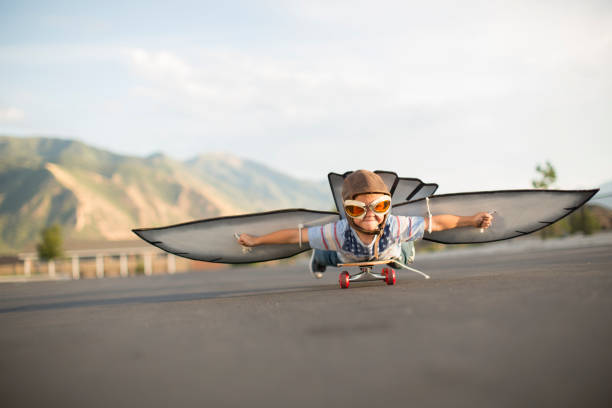 istock Young Boy Flying on Skateboard with Wings 1135838031