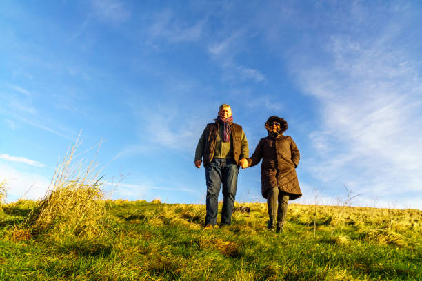 istock Senior couple walking on countryside path in winter 1135838269