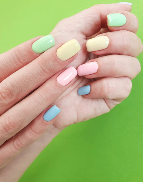 istock female hands manicure on color paper 1135840475
