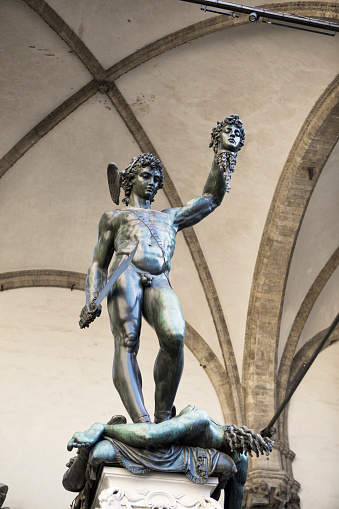 Florence, Italy - July 07, 2017: Perseus with the Head of Medusa is a bronze sculpture made by Benvenuto Cellini in 1545. Displayed in the open-air gallery of antique and Renaissance art (Loggia dei Lanzi) on the Piazza della Signoria in Florence