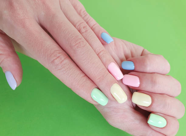 istock female hands manicure on color paper 1135840710