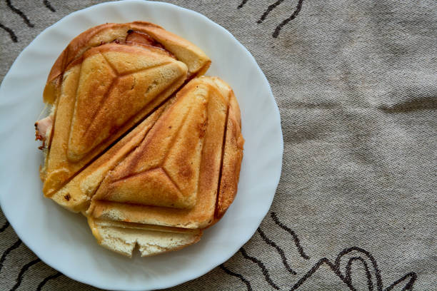 Hot Crispy Sandwich. Fresh hot crispy delicious toaster on a white plate for breakfast. Food for breakfast. Vegetarian food.