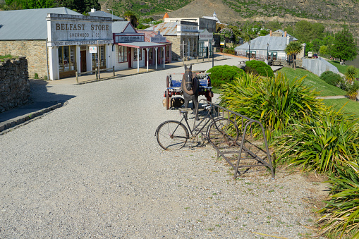 Cromwell New Zealand Heritage Precinct old gravel road in front of historic shop facades  old cycle rack and horse and cart in October 2018