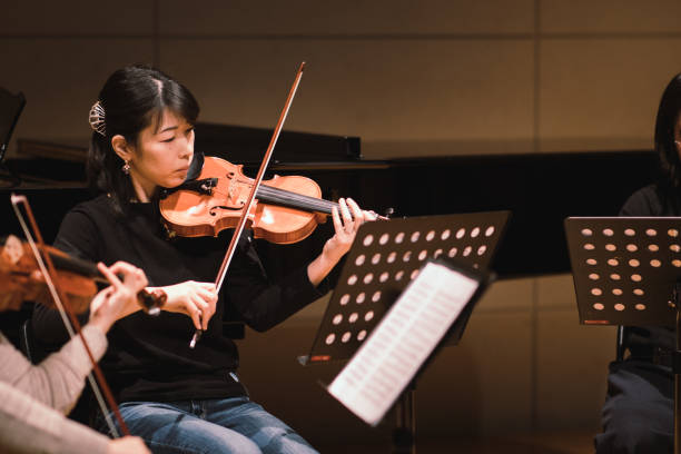 istock Musician playing violin at classical music concert 1135845237