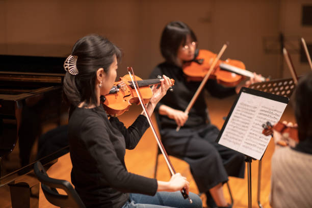 istock Three violinists playing at classical music concert 1135845357