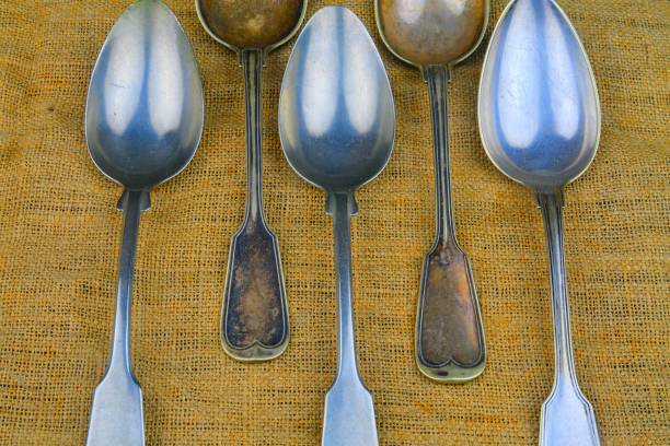 istock Old spoons on a bagging background. Five vintage spoons. Top view. Free space for text. 1135849583