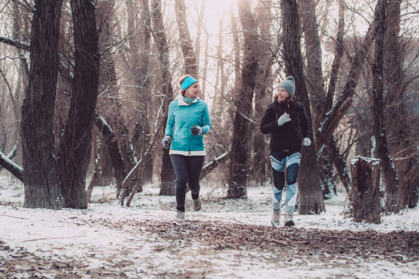 istock Women jogging in nature on a winter day 1135855397