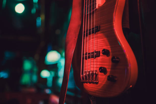 Red electric guitar and classic amplifier on a dark background