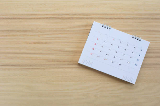 istock calendar page on wood table background 1135855572