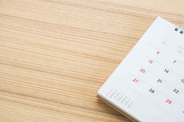 istock calendar page on wood table background 1135855574