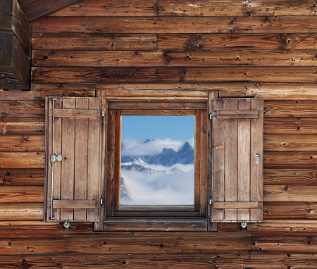 Wooden wall with window of old hotel in mountains