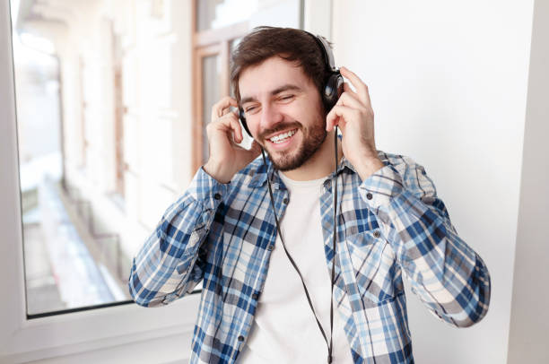 istock Modern hipster enjoying music with headphones 1135856576