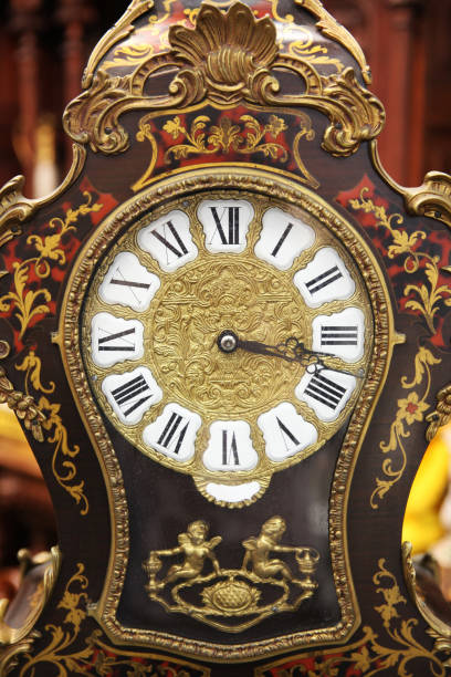 istock Ancient clock dial with Roman numerals close-up 1135859904