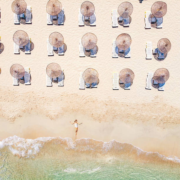 istock Beautiful Woman Lying on Sand at the Beach 1135859930