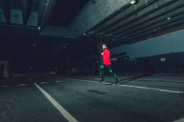 istock Man Running at Night in Los Angeles 1135862159