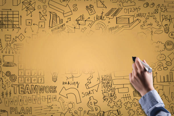 istock Female hand, holding black felt tip pen with charts and empty space for text on yellow background (Click for more) 1135862219