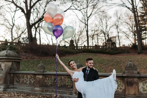 istock Grooms with Balloons in Central Park 1135868464