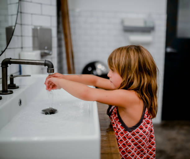 istock Child washing hands in modern bathroom 1135869324