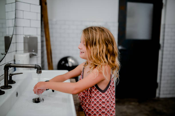istock Child washing hands in modern bathroom 1135869345