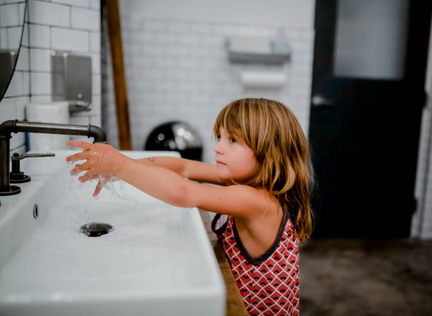 istock Child washing hands in modern bathroom 1135869347