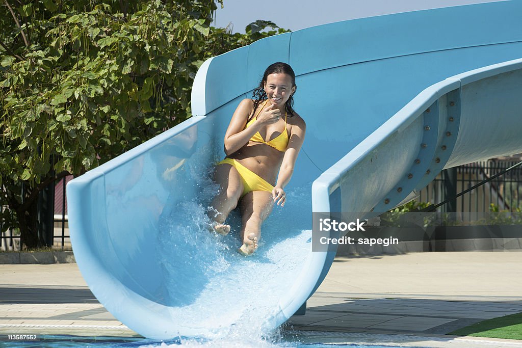 Beautiful Woman on Swimming Pool Slide  Active Lifestyle Stock Photo