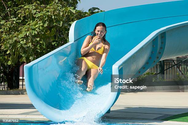 Beautiful Woman On Swimming Pool Slide Stock Photo - Download Image Now - Active Lifestyle, Activity, Adult