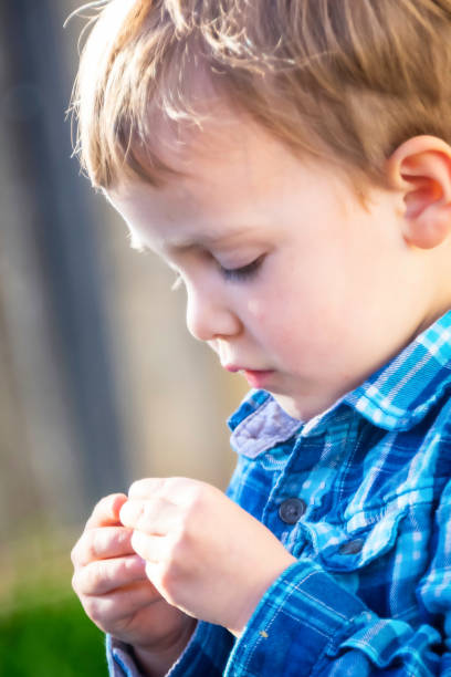 istock Pensive serious three years old child looking down 1135879870