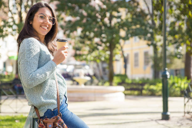 istock Smiling pretty young lady leaning on railing outdoors 1135880030