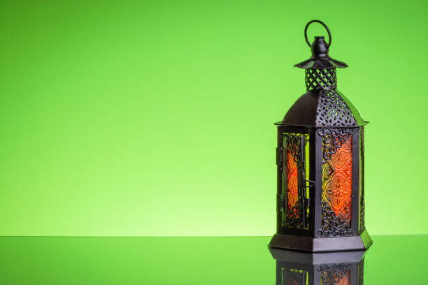 istock Ramadan lantern or Arabic decoration lamp on green background 1135880859
