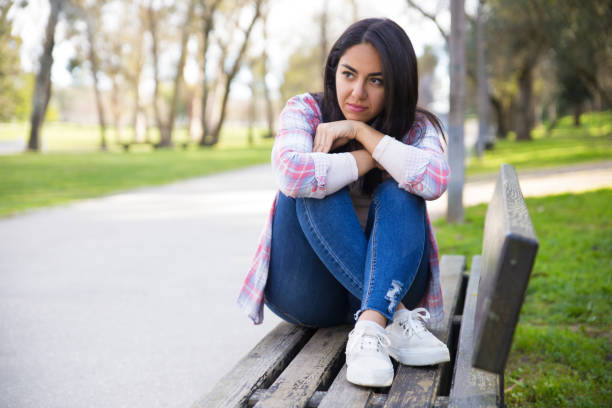 istock Pensive young woman contemplating in park 1135880986
