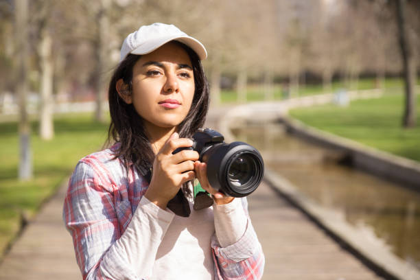 istock Focused young photojournalist working outdoors 1135881017