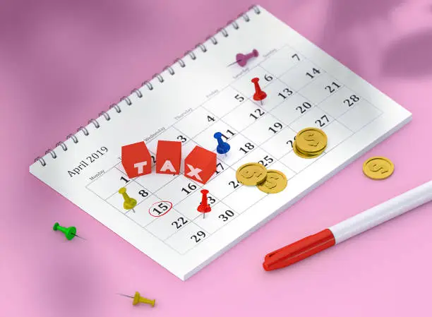 Photo of Concept image of calendar with pins and gold coins and cubes with word TAX. 3D Render Illustration isometric calendar of 15 april payday or payroll or tax. Pinned day, closeup.