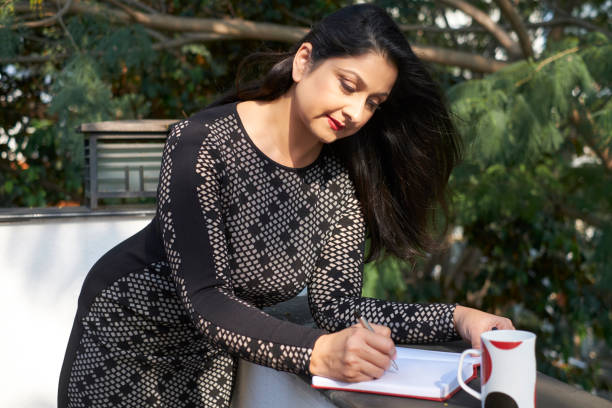 istock Pretty woman writing in diary 1135891367