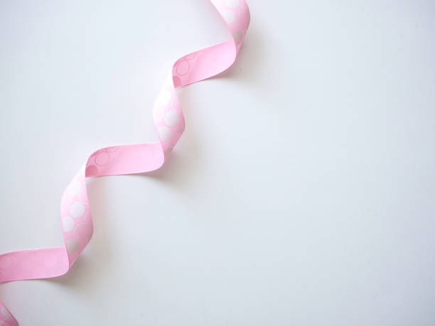 istock Pink curly ribbon on a white 1135892542