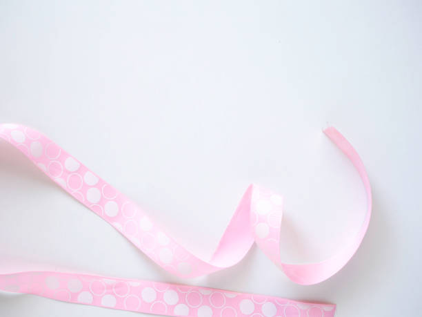 istock Pink curly ribbon on a white 1135892570