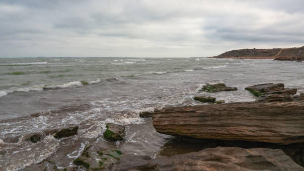 istock Rocky sea coast in cloudy weather 1135893423