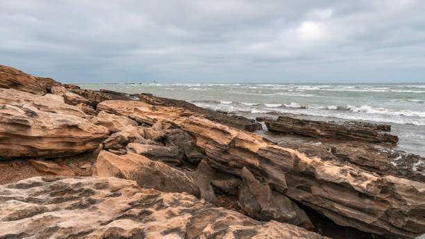 istock Rocky sea coast in cloudy weather 1135893439