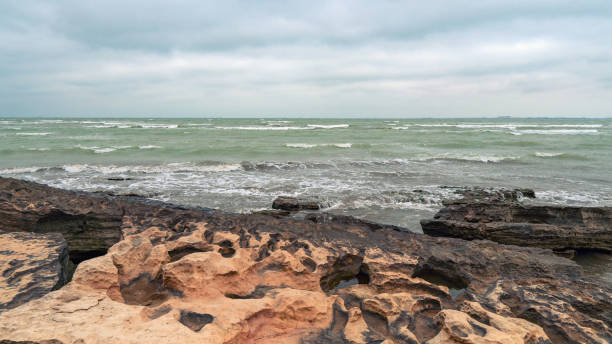 istock Rocky sea coast in cloudy weather 1135893446